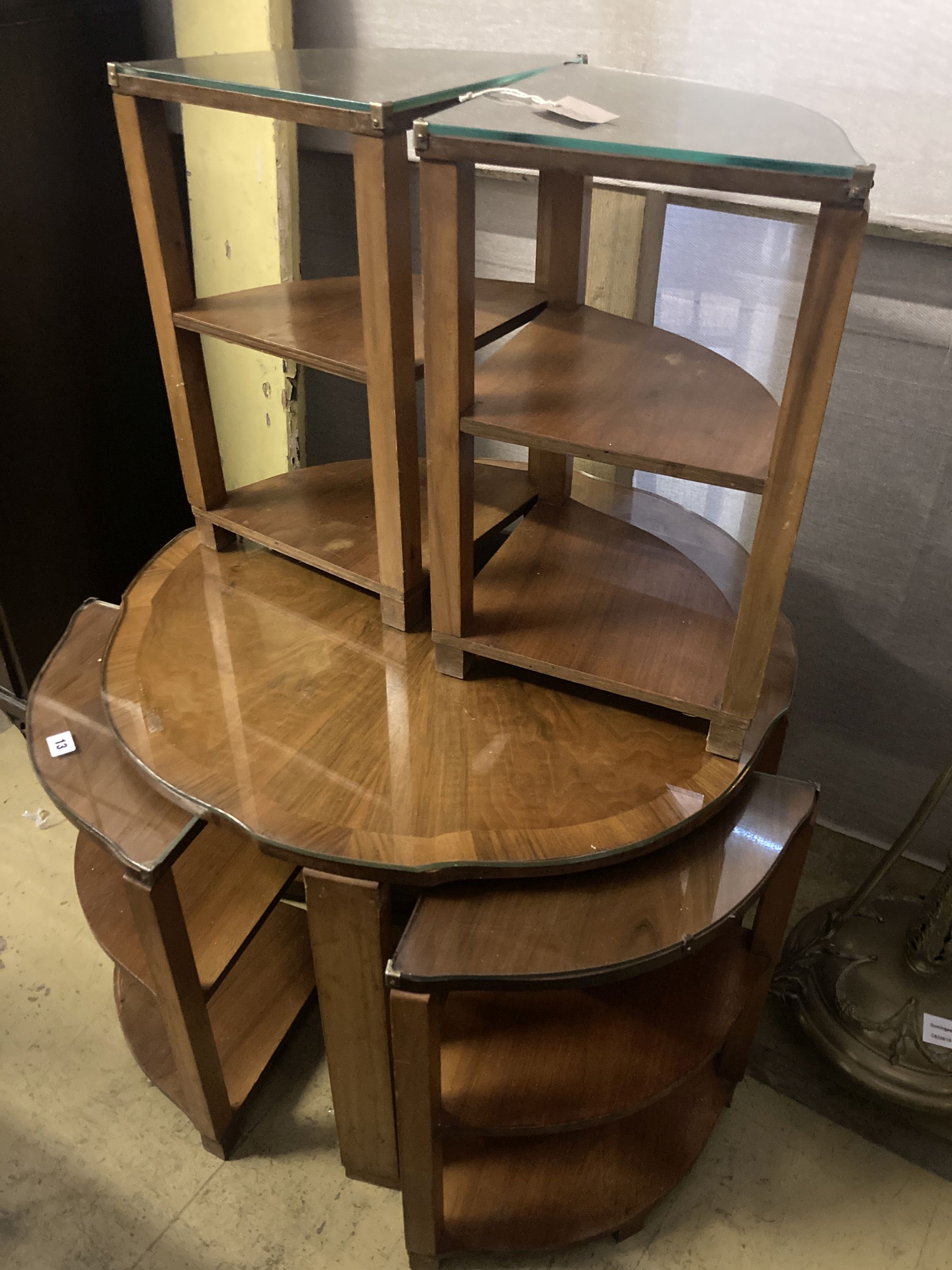 An Art Deco figured walnut nest of tables, n the manner of Epstein, diameter 74cm height 55cm